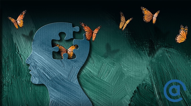 silhouette head with puzzle pieces cutout and butterflies flying arounds